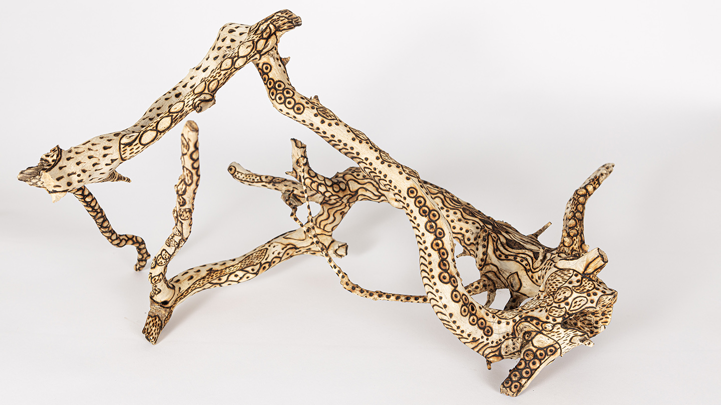 tattooed wood art piece