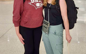 Faculty member and student at the airport on way to Ghana