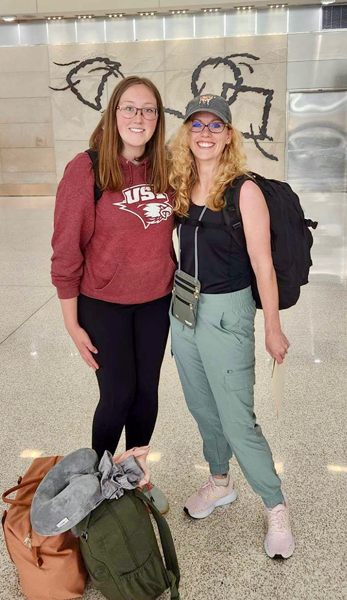 Faculty member and student at the airport on way to Ghana