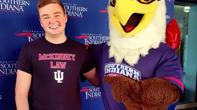 USI accounting graduate David Bradley '22 poses with Archie Eagle