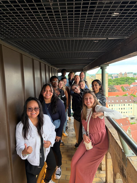 Students atop a tall bell tower 