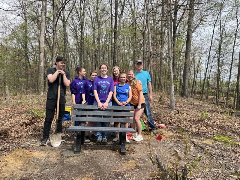 A Scouting Troop helps a 2025 Eagle Scout install some benches on Bent Twig Trail. 