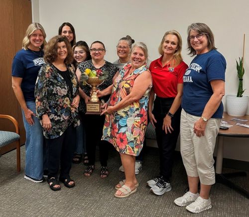 Pack the Pantry Red team members posing with the winner's trophy.