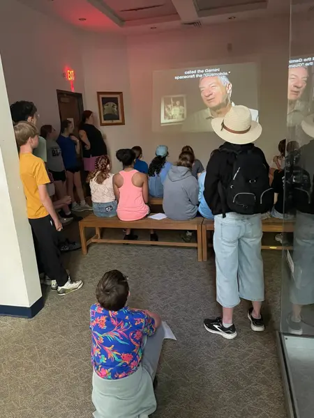 Students learn about astronaut Gus Grissom during an educational museum presentation.