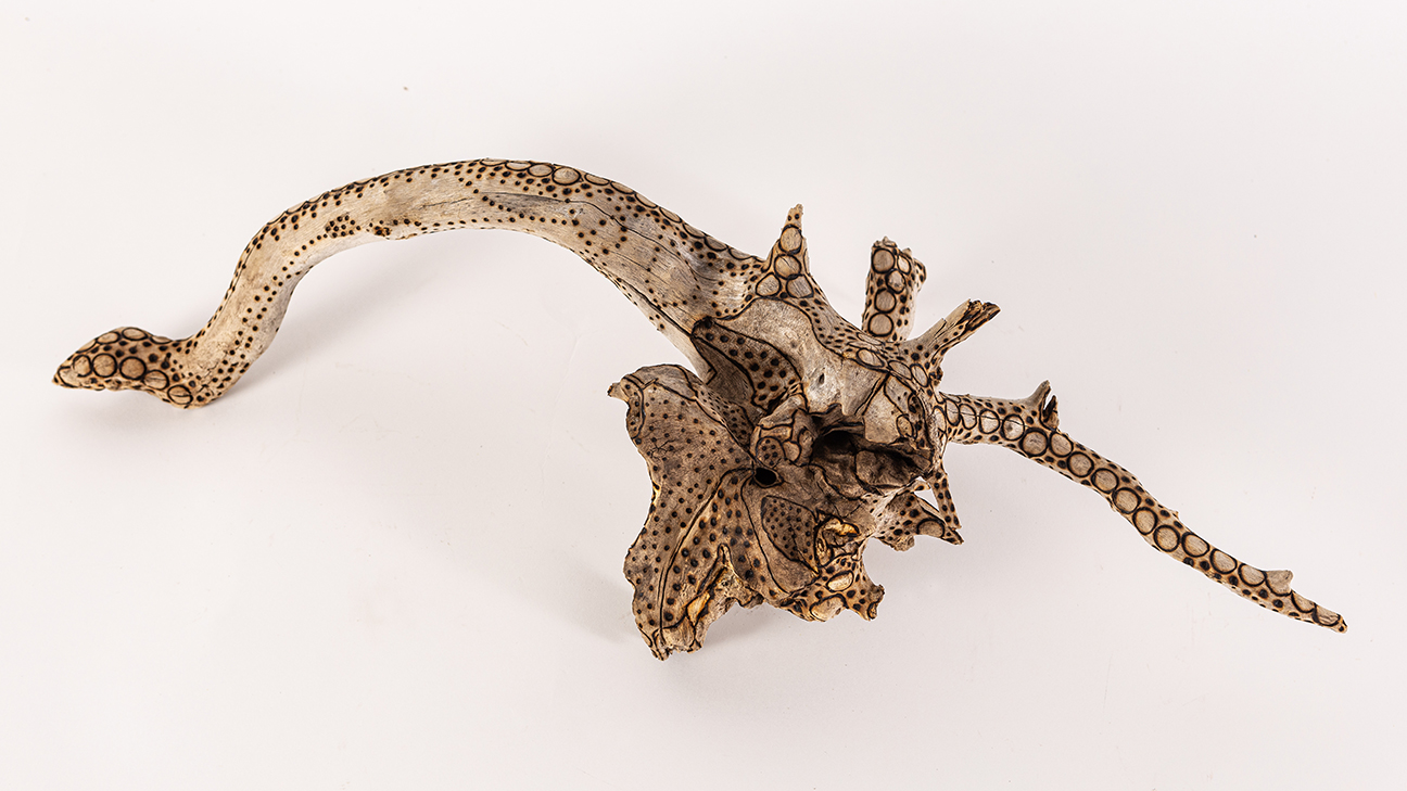 tattooed wood art piece