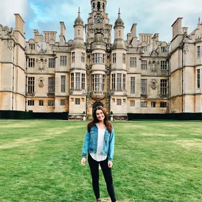 Female student poses in front of Harlaxton