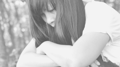 Moody black and white portrait of a woman looking away from the camera