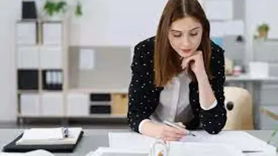 Female adult studies her notebooks and binders