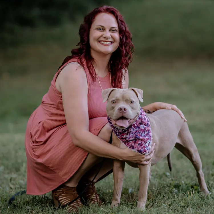 Portrait of USI pre-veterinary student Cait East with a dog