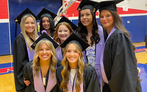 Dental assisting students at graduation wearing caps and gowns
