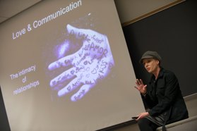 Psychology faculty member Dr. Amie McKibban lectures in front of a projector screen