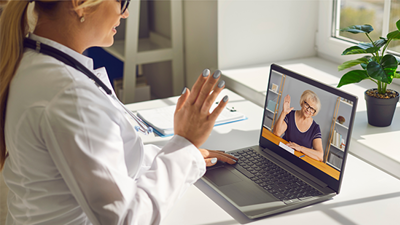 Healthcare professional conducts a telehealth session on her laptop