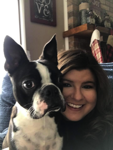 smiling woman and her black and white dog