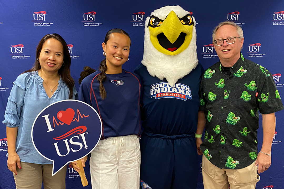 Photo of parents and high school student with Archie Eagle at Health Professions Day