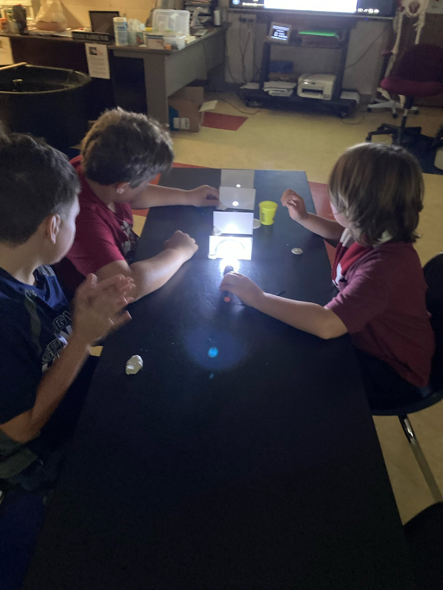 Students investigate the properties of light during a hands-on science experiment.