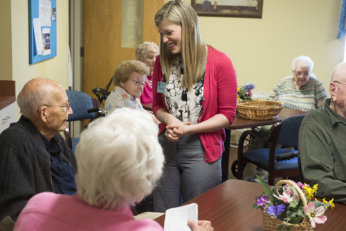 Administrator-in-Training laughing with an older adult in a nursing home