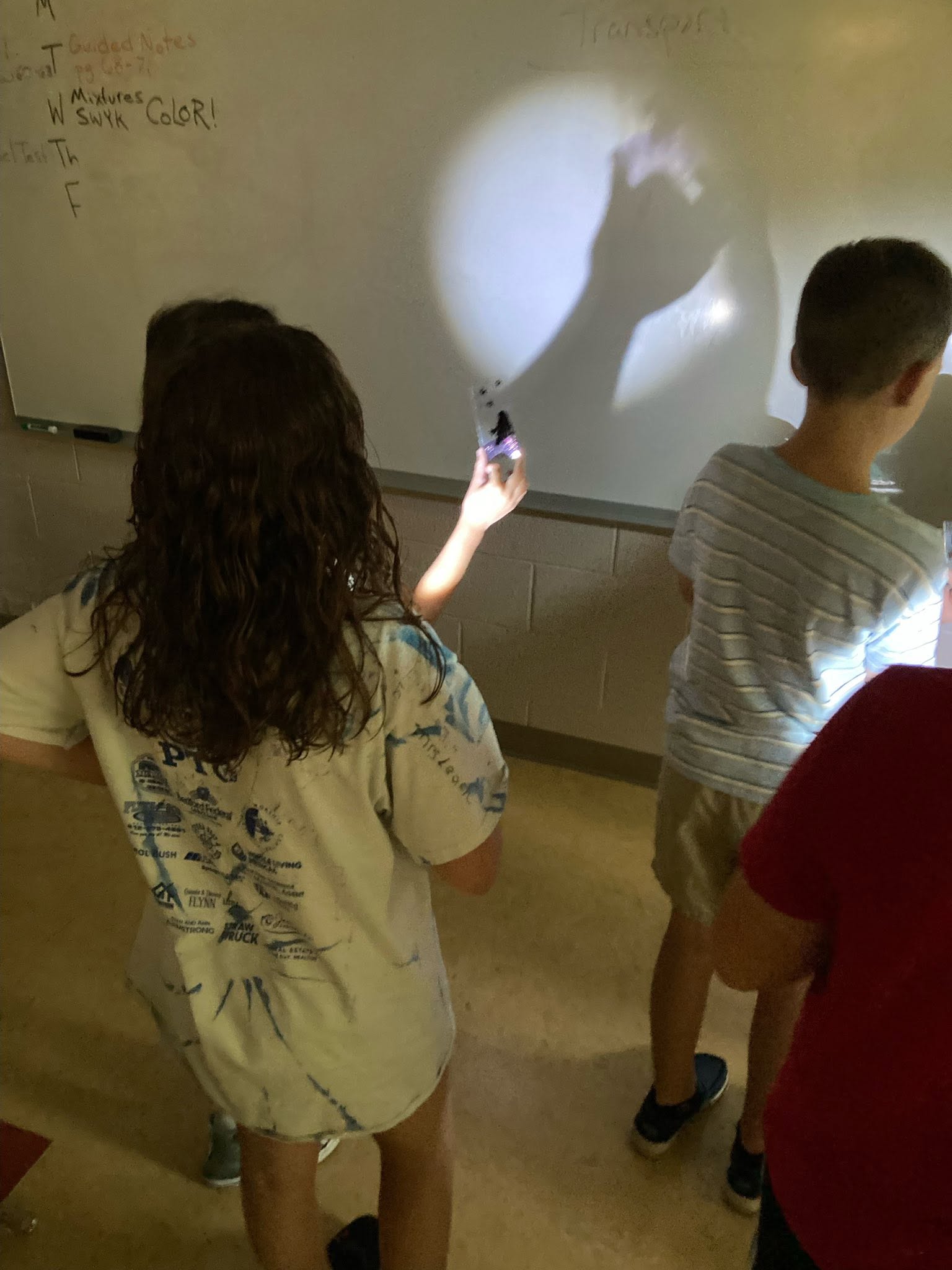 SCA Students experiment with light and shadow during an interactive science lesson.