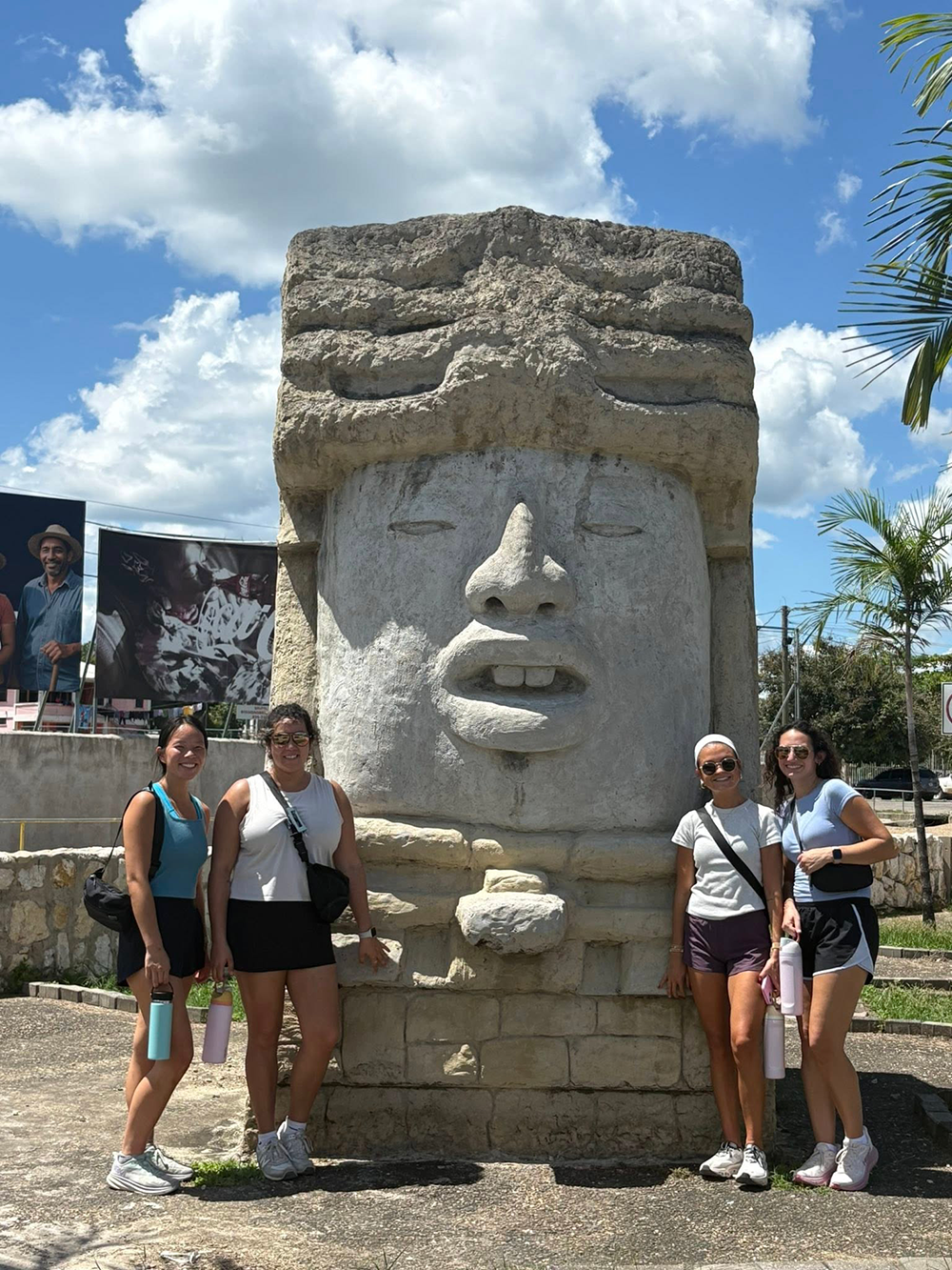 OT students pose in front of a statue