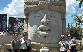 OT students pose in front of a statue