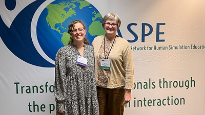 Carly Andrews and Beth Thompson at a conference