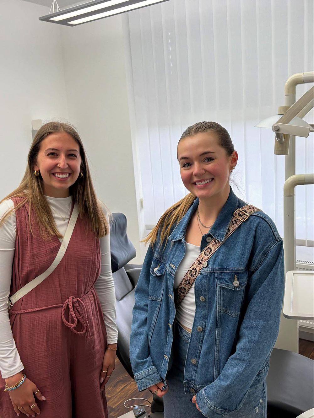Students smiling for photo inside dental office