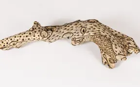 tattooed wood art piece