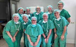 Students wearing green scrubs at German health facility