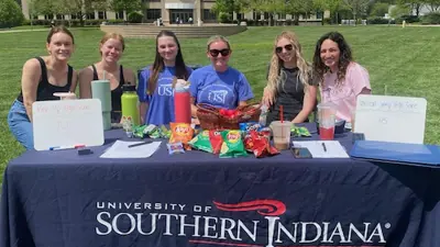 Exercise Science and Kinesiology Club members table at the Student Involvement Fair on the Quad