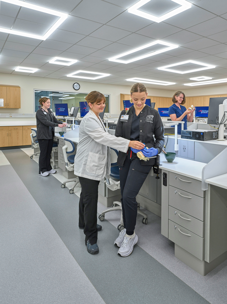 Faculty helping student in dental materials lab