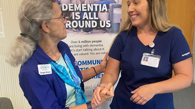 USI student shakes hands with dementia expert Teepa Snow
