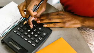 A student uses a calculator and takes notes