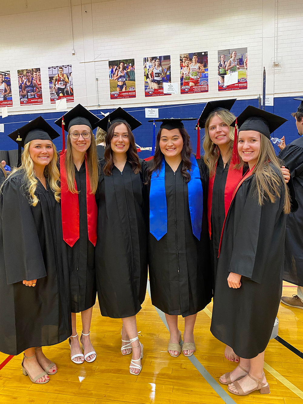 Dental hygiene students at graduation wearing caps and gowns