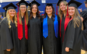 Dental hygiene students at graduation wearing caps and gowns