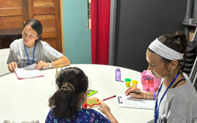Students working on fine motor skills with children