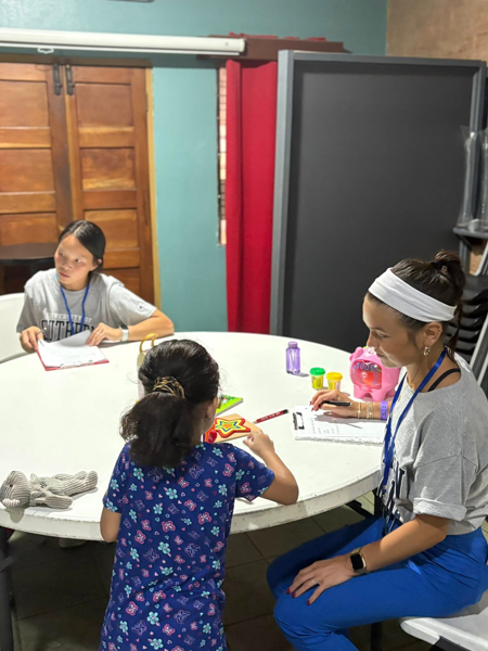 Students working on fine motor skills with children