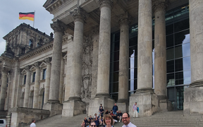 Faculty members in front of an ancient German building
