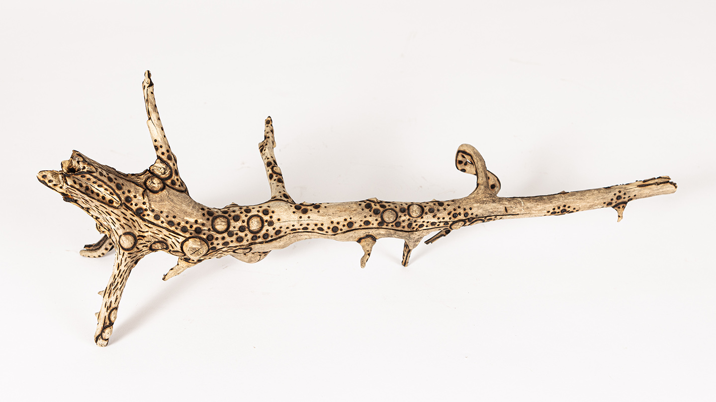tattooed wood art piece