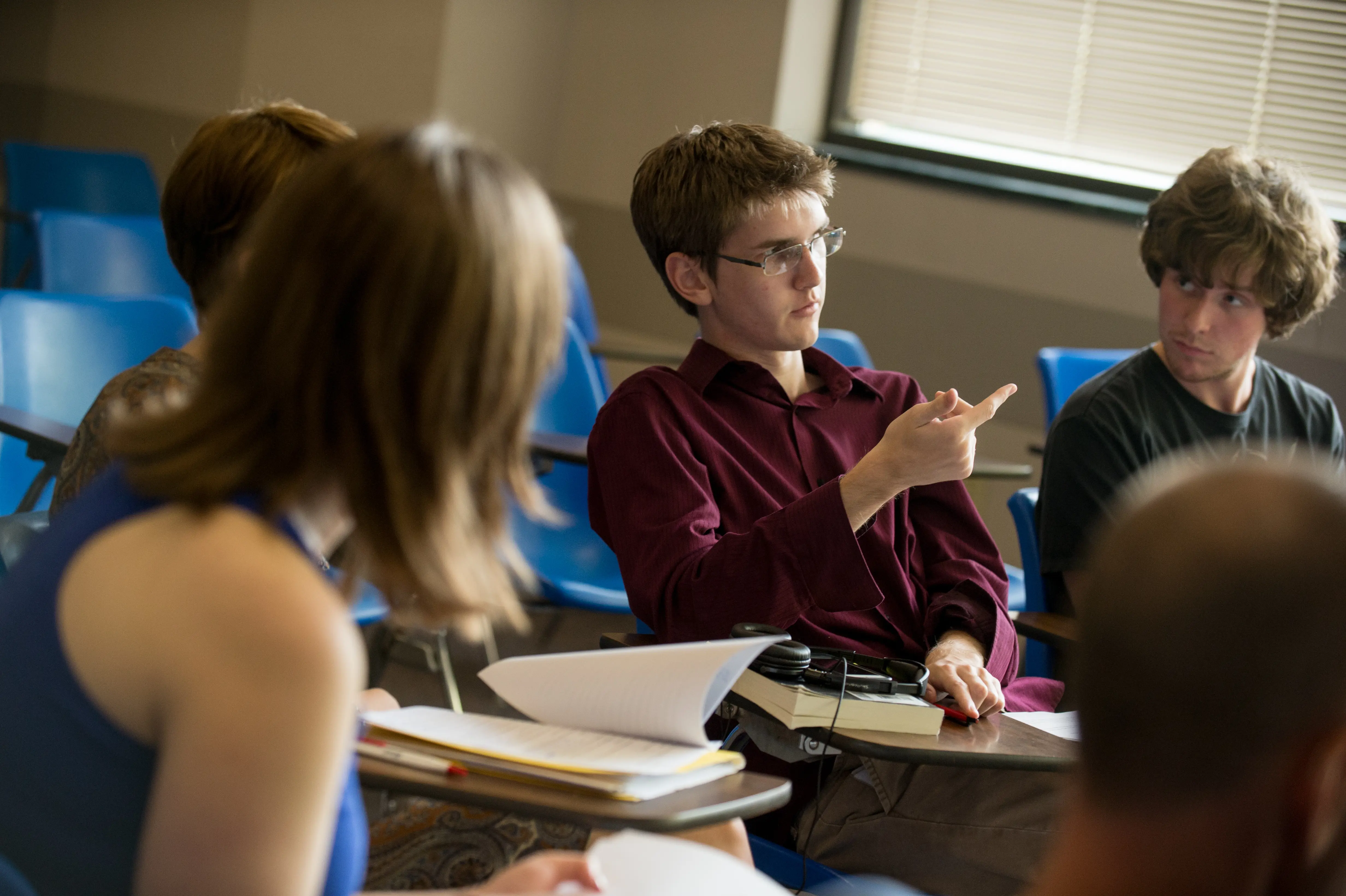 English student participates in class while other students listen