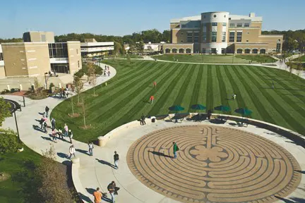 Aerial view of the labyrinth courtyard outside the Liberal Arts Center on USI's campus with the freshly mowed Quad and Rice Library in the background