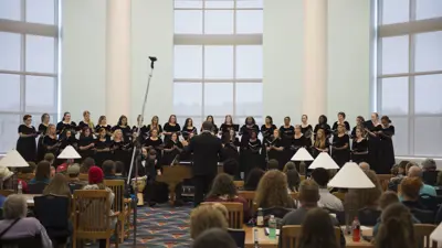 Wide view of a USI Chamber Choir performance in the Rice Library