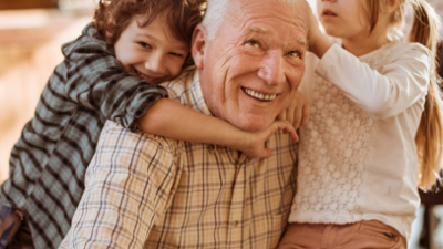 Photo of older adult with grandchildren