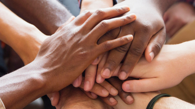Photo of hands all laying on top of each other