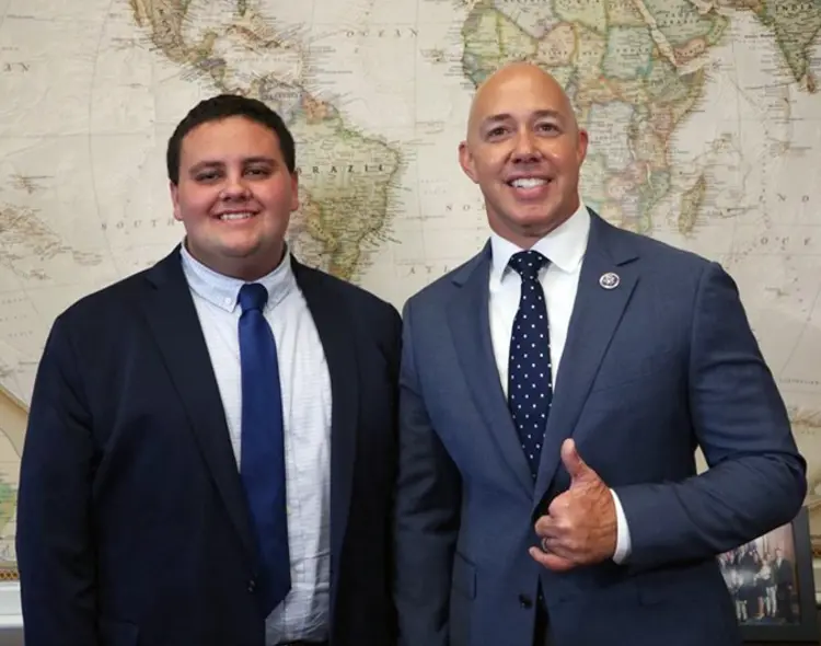Candid photo of USI political science and public relations graduate Tommy Kautzman '24 with Congressman Brian Mast