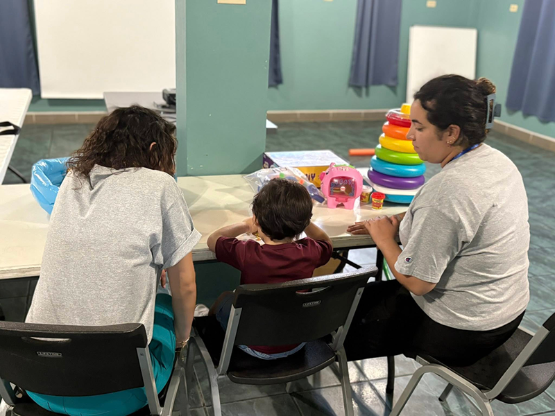 OT students working at a table with a child