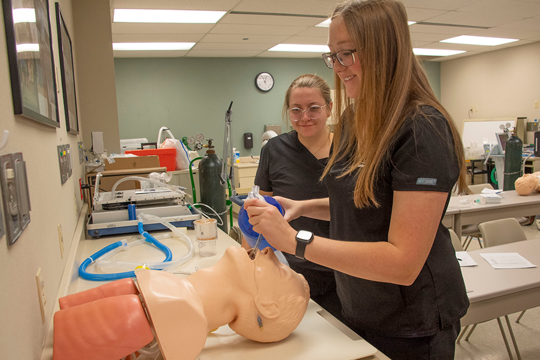 Two students in respiratory therapy lab