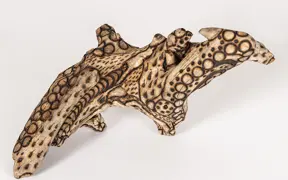 tattooed wood art piece