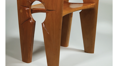 Event poster, image of wooden chair. The sides and legs are single pieces with a keyhole shape cutout. The legs frame the keyhole.