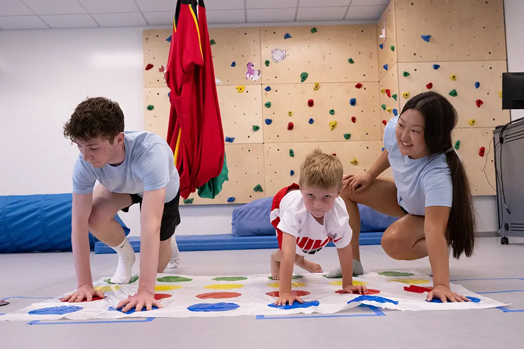 OT students playing game with child