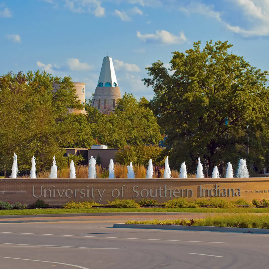 University of Southern Indiana entrance with fountain roundabout and University Center Tower in the background