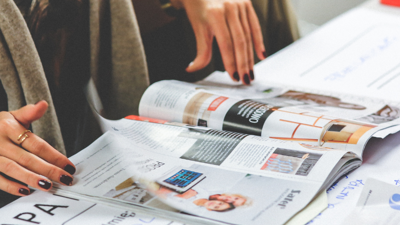 Female flips through a print magazine